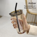 Amber breakfast glass cup with brown lid and black glass straw held by hand - Amber + Tea Lid + Black Glass Straw