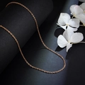 Elegant rose gold titanium steel link chain necklace on dark textured background with flowers - Rose Gold Rolo Chain