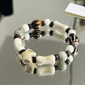 Ceramic beaded bracelet with white, beige, and bone-shaped beads on a mirror surface - Xingye (1007-07星也)