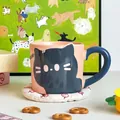 Close-up of pink ceramic cat mug with blue handle and Lucky Kitten lettering - Simple Foam Pack / Blue