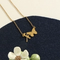 Gold stainless steel necklace featuring a butterfly and custom Xi letter pendant charm - Gold X