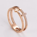 Macro shot of rose gold double-layer hollow cross ring with sparkling cubic zirconia pavé - US 5 / Rose Gold