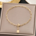 Detailed macro view of a gold paperclip chain bracelet with a square pendant on a jewelry box - Gold Paperclip Small Plate Style (5106)