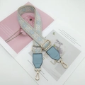 Detail of adjustable wide canvas strap with blue geometric embroidery and gold hardware - Light Blue with Light Blue Leather