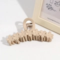 Close-up of beige matte flower hair claw clip on minimalist white surface background - Khaki