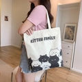 Cream canvas tote bag featuring kitten family print styled with casual summer outfit - Cat Meeting