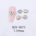 Close-up of 7.5x8mm Aurora AB heart nail charm with silver base and rhinestone edge - White Moonlight Heart Gold Base (MZH-9075)