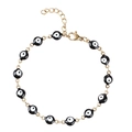 Dettaglio del bracciale a catena dorata con ciondoli occhio del diavolo bianchi e neri - Occhio Nero