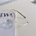 Elegant gold metal headband with white faux pearls on a glass for minimalist hair styling - Large and Small Pearls (Gold Thin Edge Beaded)