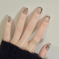 Short black branch nail art on nude base with cat eye effect and golden hollow ring - By1496 Ink Bamboo Starry Sky / Phototherapy Glue Style