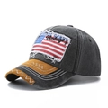 Detailed close-up of vintage washed baseball cap with American flag patch and stitched brim - One Size / Black