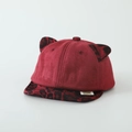 Detail of red faux suede kids baseball cap with leopard print cat ears and side label - 50cm (Recommended 1-3 Years) / Flat Cap / Burgundy