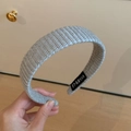 Detailed close-up of gray hand-woven knitted headband featuring FMdrea brand label - Knitted Headband / Gray