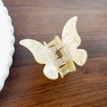 Elegant butterfly hair claw in creamy white marble finish with durable metal spring - 5.5cm / Off-white