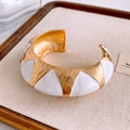 Detail of vintage gold-plated cuff bangle with hammer finish and white enamel inlay - Wide Version / Gold/White