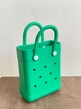 Detail of bright green EVA beach tote with signature hole design and white fasteners - Green