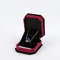 Elegant gold clover necklace with blue crystals in a red velvet octagonal jewelry box - Small Pendant Box / Bordeaux With Black Interior