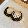 Detail view of resin C-shape hoop earrings with black tortoiseshell pattern and gold trim - 31# Silver Earring Post - Gold & Black - Resin Circle