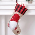 Christmas stocking with red gnome, plaid cuff and snowflake embroidery hanging on a mantel - Gnome with Heart Pattern