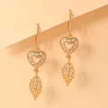 Detailed macro view of champagne gold leaf and heart-shaped earrings with white zircons - EH088 Pavé Heart Leaf Style