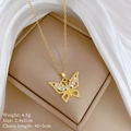 Gros plan d'un collier papillon doré serti de zircons brillants sur de la soie blanche - Style Papillon Évidé (D117)