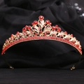 Elegant gold bridal crown with red rhinestones and intricate leaf patterns on black velvet - Gold with Red Rhinestones