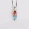 Macro shot of a hexagonal bullet-shaped crystal pendant with yellow, red and blue gradient - Yellow-Red-Blue Gradient
