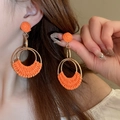 Close-up of orange woven resin hoop earrings on a model with natural lighting - 4# Steel Needle - Orange Semicircle Weave