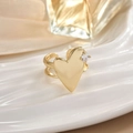 Close-up of a gold heart open ring with a small diamond inlay on a ceramic tray - Double Layer Heart Open Ring (JZ0116)