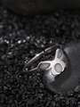 Macro shot of silver butterfly ring with white inlay on dark polished stones - Bowknot Style (NR300)