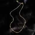 Gold-plated stainless steel bar link necklace on black silk fabric background - Corn Chain / Gold