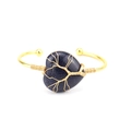 Detail of tree of life wire wrapping on heart-shaped blue sandstone gold bangle - Blue Goldstone