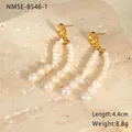 Detail view of pearl drop earrings with 4.4cm length and 8.8g weight on stone background - 18K Gold / Gold Freshwater Pearl Tassel Earrings