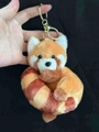 Cute red panda plush keychain featuring striped tail and golden metal lobster clasp - Donut Red Panda Light Brown