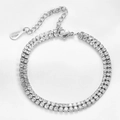 Macro shot of 6mm stainless steel tennis bracelet with double row diamonds and 18KGP tag - Steel