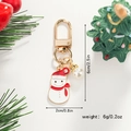 Detail of Christmas snowman keychain in gold metal with enamel and white faux pearl accent - Snowman with Red Scarf