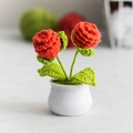 Handmade knitted lily of the valley in white pot with red crochet flowers and green leaves - Pine Cone Orange