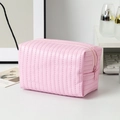 Close-up of pink PU leather makeup bag with vertical quilted texture and metal zipper - 16*9*9cm / Pink