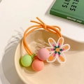 Detail of a floral hair tie with translucent flower pendant and colorful matte beads - Orange