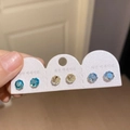 Detailed view of three pairs of round-cut crystal studs in blue and yellow on card - 31# Multicolor Round (6 Pairs)