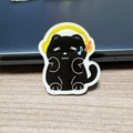 Cute black cat acrylic brooch featuring yellow headphones and colorful music notes - Headphone Black Cat