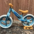 Blue and orange balancing toy bicycle keychain with Super Speed text on wooden background - Large / Blue