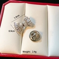 Macro shot of silver bow brooch with white zircons showing size 1.4cm by 0.9cm - C011-Silver Bow