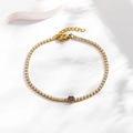 Detailed view of gold tennis bracelet featuring purple zircon stone and lobster clasp - Round Purple Zirconia