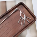 Detail of silver tassel hair pin with hollow tower design on a rustic wooden tray - F0742 Hair Stick-15# (Minimalist Geometric Rhombus Tassel)