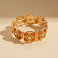 Dettaglio macro del bracciale con perle rétro con base in metallo dorato e elastico - Oro-Perla geometrica a rombo