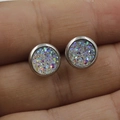 Macro shot of 8mm rainbow druzy stud earrings on a finger showing the scale and texture - Aurora/Rainbow (9)
