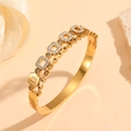 Macro detail of gold geometric open bangle featuring sparkling cubic zirconia crystals - Gold Square Geometric Style (N213)