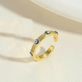 Macro shot of 14K gold plated Evil Eye open ring with blue stones on beige fabric - Royal Blue (JZ0377-2)