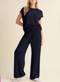 Close-up of women's ribbed knit two-piece set featuring short sleeve top and wide leg pants - Navy Blue